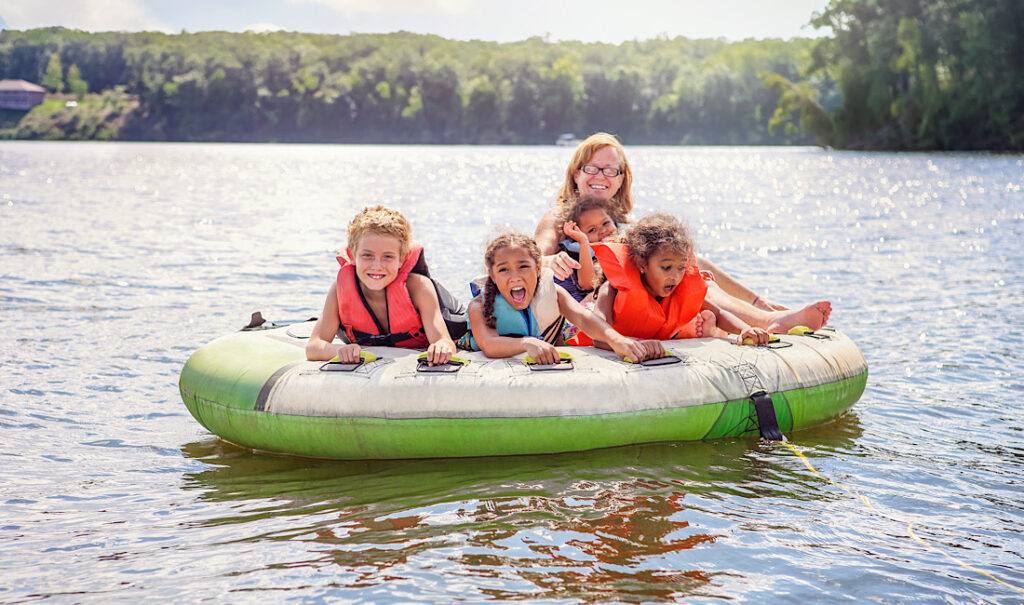Happy, smiling family tubing on Vail's Gore Creek in Colorado.
