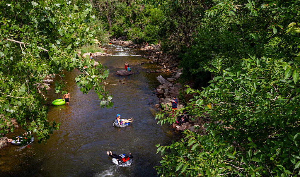 River tubing down Gore Creek in the fall in Vail, CO.