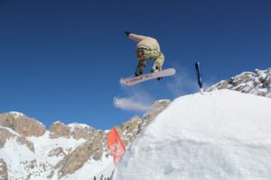 snowboarder going off jump